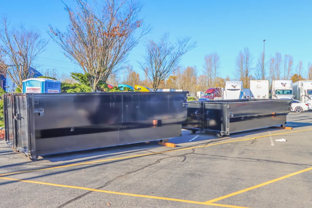 Professional dumpster rental service with roll-off container on residential driveway in Takoma Park